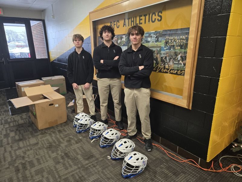 Bishop Foley Catholic players with donated lacrosse helmets