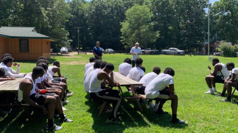 A team gathered outdoors during a Handoff visit